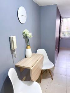 帕斯托Hermoso apartaestudio moderno valle de atriz norte的一间带木桌和白色椅子的用餐室