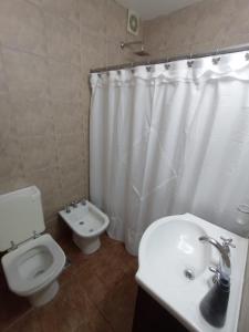布宜诺斯艾利斯Depto Caba Floresta的浴室设有卫生间和白色的淋浴帘
