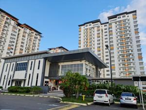 帕帕尔RHR Deluxe GuestHouse Kinarut Papar Sabah - Pool View的停车场内有车辆的建筑物