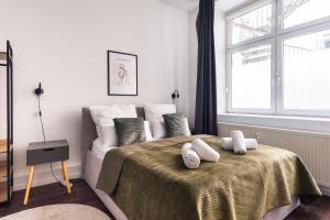 柏林Central Apartment in Heart of Berlin的卧室配有带白色枕头的床和窗户。