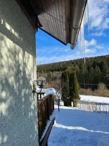弗林布尔克Chata Monika的雪中从房子的一侧挂起的琴