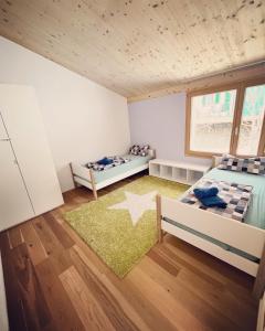 上萨克森3 bedroom condo in front of Obersaxen ski resort的一间带两张床的卧室和星空地毯