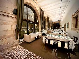 莱昂圣依西多禄皇家教堂酒店的餐厅内带桌椅的用餐室