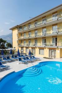 布雷佐内加尔达Hotel Drago - Garda Lake Collection的一座带游泳池和椅子的酒店和一座建筑