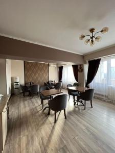 比什凯克Seven Hotel Bishkek的用餐室设有桌椅和窗户。