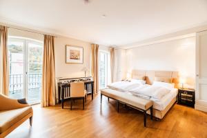 温克尔瑞恩斯尔兹酒店的白色卧室配有床、书桌和书桌