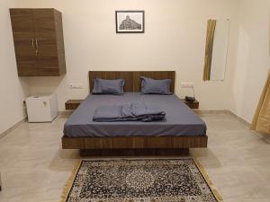 阿利鲍格Sk Resort的一间卧室配有一张大床,床上铺有蓝色的床单和地毯。