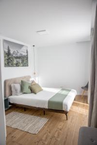 莱斯诺夫Mountain Lodge的白色卧室配有带枕头的床