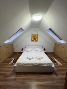 锡纳亚Springbok - Sinaia的阁楼上的卧室配有一张大床