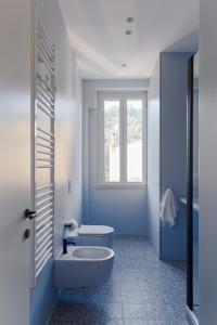 罗马Olimpico Apartment - Zen Real Estate的蓝色的浴室设有卫生间和窗户。