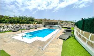 比拉夫洛尔Casa Rural Finca Paraíso. Heated pool的一个带椅子和围栏的庭院内的游泳池