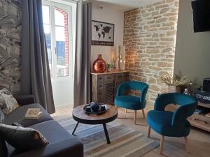 孔卡尔诺appartement topaze的客厅配有沙发、两把椅子和一张桌子
