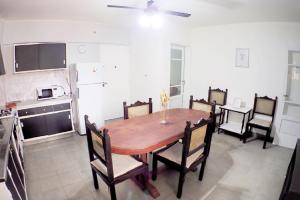 BarraqueroDepartamento Bouquet的厨房以及带木桌和椅子的用餐室。