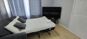 韦克斯福德Apartment in the heart of wexford town的客房设有床、沙发和电视。