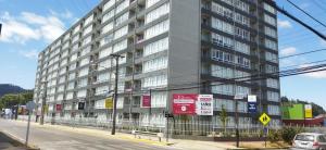 特木科Acogedor departamento en Temuco的城市街道上的大型公寓楼