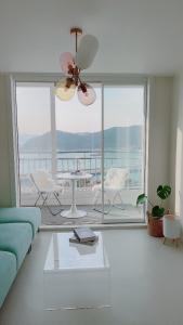统营市Tongyeong Canal Ocean View的客厅配有蓝色的沙发和吊扇
