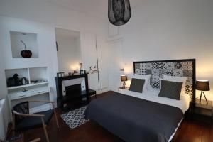 亚眠Ginkgo Maison d'hôtes的一间卧室设有一张大床和一个壁炉