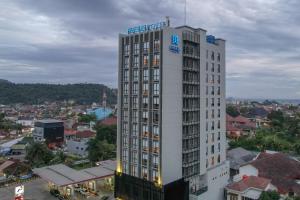 班达楠榜楠榜巴提夸酒店的一座高大的白色建筑,上面有标志