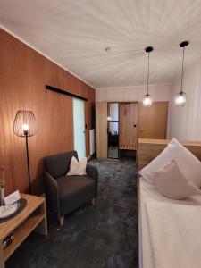 巴特拉尔Hotel Pieper-Kersten的配有一张床和一把椅子的酒店客房