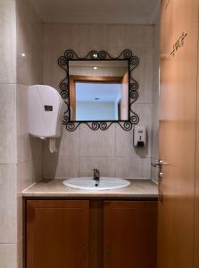 波尔图帕伊茨酒店的一间带水槽和镜子的浴室