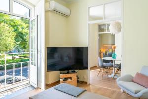 塞图巴尔Casa St Yves - Sunny flat in Setúbal on Av Luisa Todi的客厅配有大屏幕平面电视