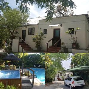 斯泰伦博斯Santika Getaway Cottage Stellenbosch的一座房子前面设有游泳池