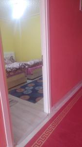 Çiftlik otel的一间红色门的房间和一间带床的房间