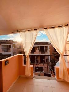 维拉西米乌斯Casa Jane的阳台配有窗帘,享有建筑的景致。