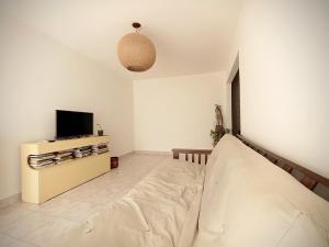 佩里托莫雷诺Kau hostel & experiencias的一间带床和电视的客厅