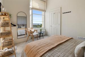 廷茅斯Seabreeze的一间卧室设有一张床、梯子和窗户