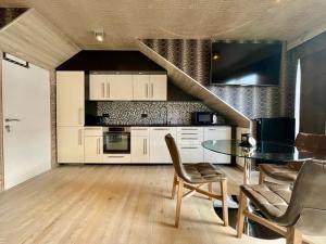 马尔梅迪Guesthouse ROOM40的一间带桌椅和楼梯的厨房