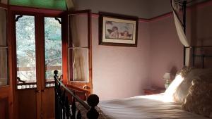 GlenifferFreida - Historic Farmhouse Bellingen的一间卧室设有一张床和一个大窗户
