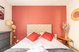 克莱蒙费朗L'adorable Confort & Central的一间卧室设有红色的墙壁和一张带红色枕头的床