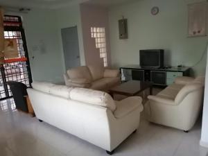 麻坡JOYFIN homestay roomstay muar的客厅配有沙发、椅子和桌子