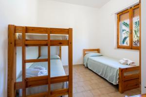 阿尔盖罗奥西斯公寓式酒店的一间卧室设有两张双层床和一扇窗户。