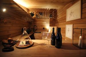 蓬德利马Vinha by NHôme的一间房间,桌子上放有酒瓶和玻璃杯