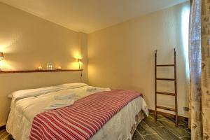 库马约尔Appartamento Eve的一间卧室配有带条纹毯子的床