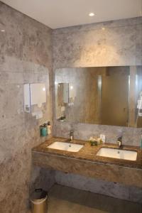 科贾埃利5 yıldızlı Dedeman’da özel residence dairesi的一间带两个盥洗盆和大镜子的浴室