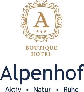 滕嫩山麓圣马丁Boutique Hotel Alpenhof的带有顶部的豪华酒店标志