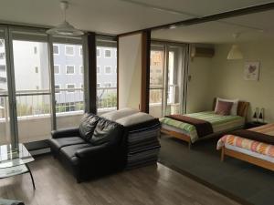 长野罗盘公寓的带沙发、床和窗户的客厅