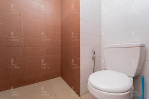 雅加达RedLiving Apartemen Puri Orchard - Prop2GO Home Tower Magnolia的浴室设有白色卫生间和棕色瓷砖。