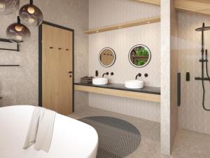 比希尔巴赫Cosy, new chalet with garden and private sauna的浴室配有两个盥洗盆和浴缸。