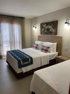 皮雷诺波利斯Resort Quinta Santa Barbara 18 a 24 Agosto的一间卧室配有一张大床和两个枕头