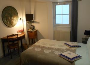 奥尔斯克维莱封地庄园旅馆的一间卧室配有一张床、一张书桌和一个窗户。