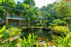 富国Lahana Resort Phu Quoc & Spa的房屋前带池塘的花园
