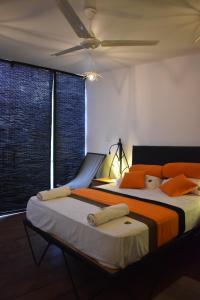 库鲁内格勒Kakulanda Resort的一间卧室配有两张带橙色和白色枕头的床