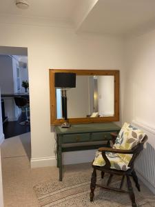 卡比斯贝Sandsifter at 4 Trencrom Court, Carbis Bay,St Ives, Cornwall的客房设有镜子、椅子和书桌