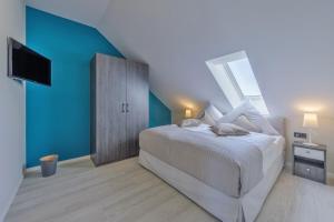 欧巴德伍斯图Duenenrast in der Seefahrtschule的一间卧室设有一张大床和蓝色的墙壁