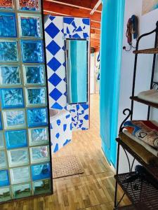 拉拉古纳Atico de la Pardela的客房铺有蓝色和白色的瓷砖,配有镜子
