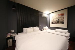 釜山2 Heaven Hotel Songdo的一张大白色的床,位于酒店客房内